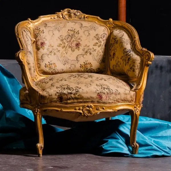 Poltroncina in stile Luigi XV dorata e intagliata, con tessuto a fiori